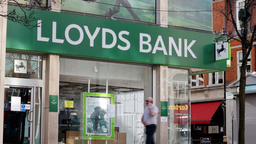 A pedestrian walks past a branch of a Lloyds Bank in London on Feb. 24, 2021.